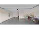 Spacious garage with epoxy flooring, white walls, and ample storage space at 10324 Stroma Ave, Las Vegas, NV 89166