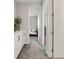 Neutral hallway featuring gray carpet, white doors, and built-in storage cabinets at 10324 Stroma Ave, Las Vegas, NV 89166