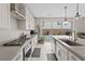 Bright kitchen featuring a large island, stainless steel appliances, and sliding glass doors to the backyard at 10324 Stroma Ave, Las Vegas, NV 89166