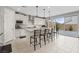 Modern kitchen featuring a large island, stainless steel appliances, and sliding glass doors to the backyard at 10324 Stroma Ave, Las Vegas, NV 89166