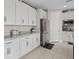 Modern kitchen featuring white cabinets, stainless steel appliances, and tile flooring at 10324 Stroma Ave, Las Vegas, NV 89166