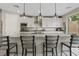 Bright kitchen featuring white cabinets, an island with seating, and modern appliances at 10324 Stroma Ave, Las Vegas, NV 89166
