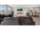 Bright living room with gray sofa, large windows, modern fireplace, and dining area at 10324 Stroma Ave, Las Vegas, NV 89166