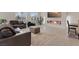 Open concept living room featuring a linear fireplace and tile flooring throughout at 10324 Stroma Ave, Las Vegas, NV 89166