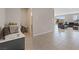 Open-concept living room features tile flooring and leads to a large outdoor space at 10324 Stroma Ave, Las Vegas, NV 89166