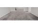 Expansive living room featuring gray carpet and an open floorplan at 10324 Stroma Ave, Las Vegas, NV 89166