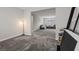 Spacious living room featuring gray carpet, an open floorplan, and modern decor at 10324 Stroma Ave, Las Vegas, NV 89166