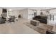 Open concept living room and kitchen area with modern tile flooring and dining area at 10324 Stroma Ave, Las Vegas, NV 89166