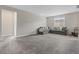 Spacious living room with large windows and plush carpeting at 10324 Stroma Ave, Las Vegas, NV 89166