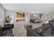 Open living area showcasing a modern fireplace, large gray sofa, and dining table at 10324 Stroma Ave, Las Vegas, NV 89166