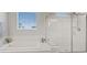 Bright bathroom featuring a soaking tub and separate glass-enclosed shower at 10324 Stroma Ave, Las Vegas, NV 89166