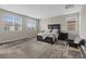 Spacious main bedroom featuring a large bed, multiple windows, and gray carpet at 10324 Stroma Ave, Las Vegas, NV 89166