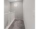 Carpeted stairs featuring a white bannister and a porthole window at 10324 Stroma Ave, Las Vegas, NV 89166
