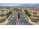 Gated community entrance with well-maintained landscaping and a view of the mountains in the background at 10324 Stroma Ave, Las Vegas, NV 89166