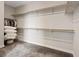 Large walk-in closet with custom wood shelving and carpet flooring at 10324 Stroma Ave, Las Vegas, NV 89166