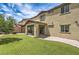 Beautiful backyard showcasing artificial grass, a covered patio, and the home's exterior at 10623 Auburn Springs Ave, Las Vegas, NV 89166