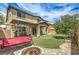 Inviting backyard with lush lawn, covered patio, swing, and fire pit, perfect for outdoor relaxation and entertainment at 10623 Auburn Springs Ave, Las Vegas, NV 89166