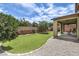 Lush backyard with artificial grass, mature trees, and a covered patio area perfect for outdoor gatherings at 10623 Auburn Springs Ave, Las Vegas, NV 89166