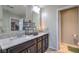 Double sink vanity bathroom featuring granite countertops, modern fixtures and access to the toilet room at 10623 Auburn Springs Ave, Las Vegas, NV 89166