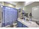Cozy bathroom features a granite vanity top and combined shower and tub at 10623 Auburn Springs Ave, Las Vegas, NV 89166