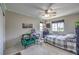 Bright bedroom with a comfortable bed, gamer chair and large windows offering great views at 10623 Auburn Springs Ave, Las Vegas, NV 89166