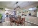Open-concept dining area with a modern light fixture and views into the kitchen and living areas at 10623 Auburn Springs Ave, Las Vegas, NV 89166