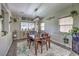 Cozy dining room with a classic wooden table, decorative plants, and natural light at 10623 Auburn Springs Ave, Las Vegas, NV 89166
