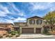 Two-story home boasts a multi-car garage, complemented by charming shutters and landscaped front yard at 10623 Auburn Springs Ave, Las Vegas, NV 89166