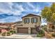 Two-story home boasts a multi-car garage, complemented by charming shutters and landscaped front yard at 10623 Auburn Springs Ave, Las Vegas, NV 89166
