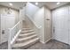 Inviting hallway with carpeted stairs, neutral tones, and tile flooring at 10623 Auburn Springs Ave, Las Vegas, NV 89166