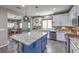 Gourmet kitchen with granite counters, white cabinets, stainless steel appliances and a center island at 10623 Auburn Springs Ave, Las Vegas, NV 89166