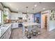 Modern kitchen with stainless appliances, island seating, and updated lighting at 10623 Auburn Springs Ave, Las Vegas, NV 89166