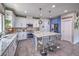 Updated kitchen boasting an island with seating, white cabinets, and stainless steel appliances at 10623 Auburn Springs Ave, Las Vegas, NV 89166