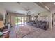Open living room with tiled floors, slider to backyard, and reclining sofa at 10623 Auburn Springs Ave, Las Vegas, NV 89166