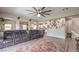 Inviting living room boasts tile flooring, a modern ceiling fan, and seamless access to the kitchen at 10623 Auburn Springs Ave, Las Vegas, NV 89166