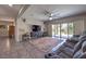 Spacious living room featuring tile floors, a large rug, and sliding door access to the backyard at 10623 Auburn Springs Ave, Las Vegas, NV 89166