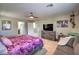 Cozy main bedroom featuring a ceiling fan, sitting area and access to ensuite bathroom and closet at 10623 Auburn Springs Ave, Las Vegas, NV 89166