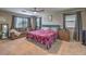 Spacious main bedroom with a ceiling fan, sitting area, and ample natural light from large windows at 10623 Auburn Springs Ave, Las Vegas, NV 89166