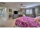 Comfortable main bedroom featuring a sitting area, ceiling fan, and access to closet at 10623 Auburn Springs Ave, Las Vegas, NV 89166