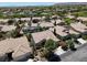 High aerial shot that shows many houses in a well-kept neighborhood filled with luscious green landscaping at 10805 Hollow Creek Ln, Las Vegas, NV 89144