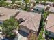 An eye-level aerial view that shows many houses with well-kept landscapes in a cozy-looking neighborhood at 10805 Hollow Creek Ln, Las Vegas, NV 89144