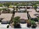 A high aerial view that shows a well-kept neighborhood with luscious green landscaping surrounding many houses at 10805 Hollow Creek Ln, Las Vegas, NV 89144
