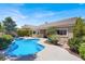 Inviting backyard oasis with a sparkling pool, spa, lush landscaping, and manicured yard at 10805 Hollow Creek Ln, Las Vegas, NV 89144