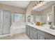 Bright bathroom features double vanity sinks with a separate bathtub and shower with glass doors at 10805 Hollow Creek Ln, Las Vegas, NV 89144
