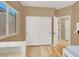 Bedroom with wood floors, bunkbed, closet, and natural light through the window at 10805 Hollow Creek Ln, Las Vegas, NV 89144