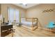 Comfortable bedroom with a bunkbed, wood floors and modern decor with access to natural light at 10805 Hollow Creek Ln, Las Vegas, NV 89144