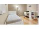 Well lit bedroom with bed, desk, bookshelf, and light colored wood floors at 10805 Hollow Creek Ln, Las Vegas, NV 89144