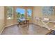 Cozy dining area with large windows that provide plenty of natural light and warmth at 10805 Hollow Creek Ln, Las Vegas, NV 89144