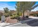 Attractive one-story home showcasing desert landscaping and a well-maintained yard at 10805 Hollow Creek Ln, Las Vegas, NV 89144