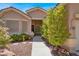 Inviting entrance showcasing a well-lit doorway, desert landscape, and cozy walkway at 10805 Hollow Creek Ln, Las Vegas, NV 89144